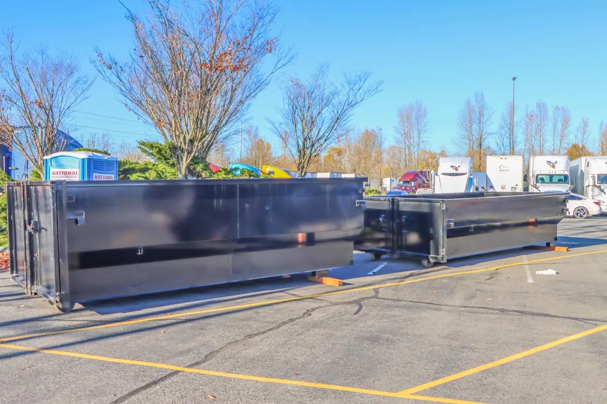 Professional dumpster rental service with roll-off container on residential driveway in Webster
